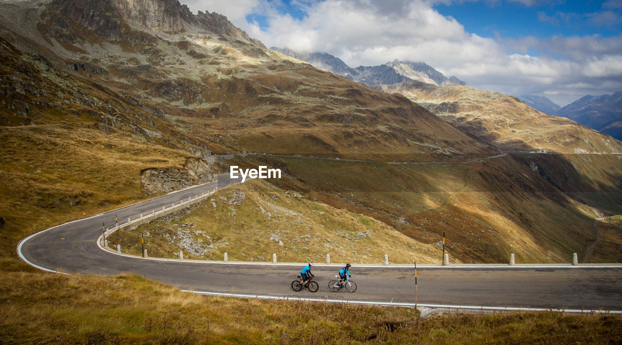 High angle view of people cycling on mountain road