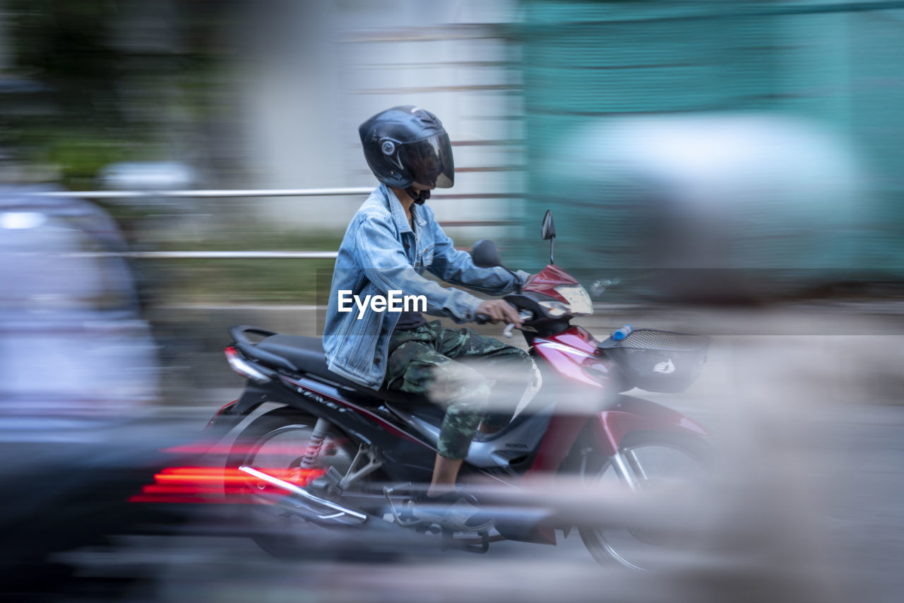 Motion blur of a woman riding a motorcycle