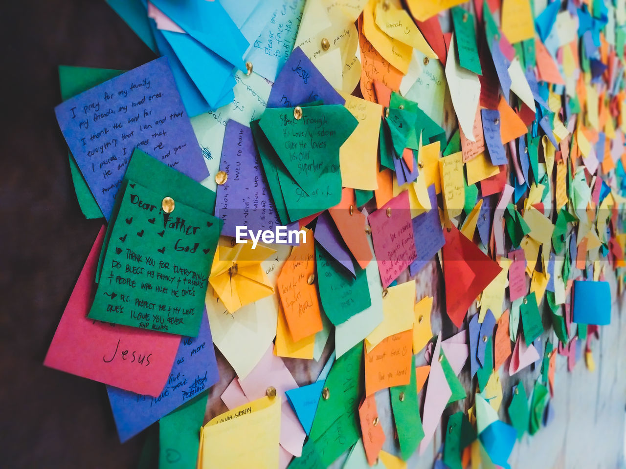 Close-up of prayer messages papers attached on board at church