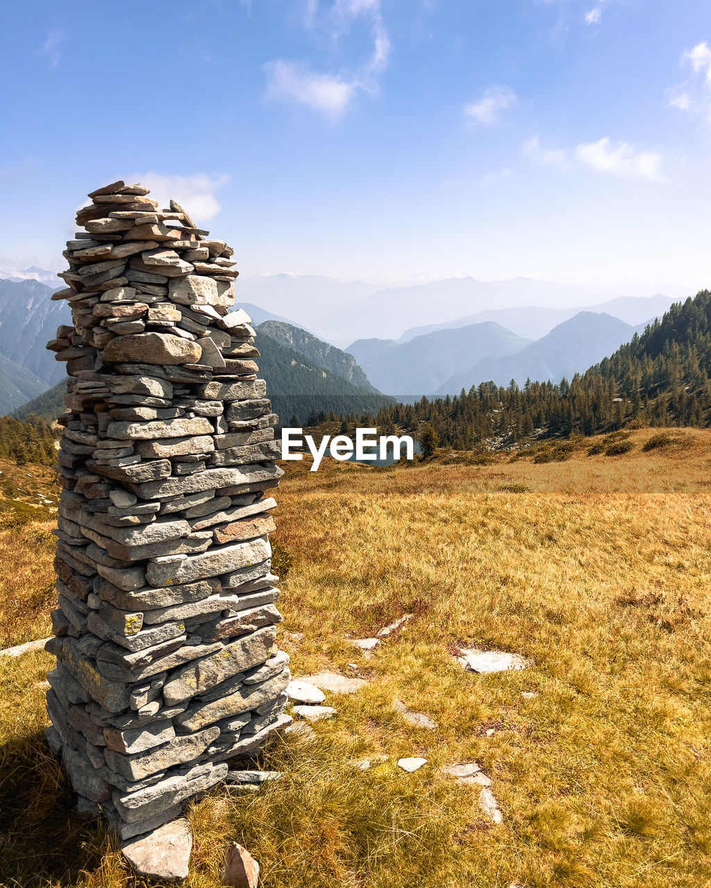 rock, wilderness, mountain, sky, landscape, nature, environment, scenics - nature, mountain range, land, plant, beauty in nature, no people, tranquility, tranquil scene, travel destinations, tree, non-urban scene, geology, day, travel, cloud, sunlight, outdoors, coniferous tree, grass, pinaceae, forest, rural scene, pine tree, balance, idyllic, field