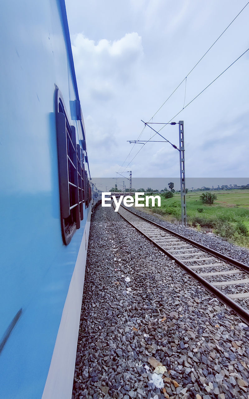 sky, transportation, cloud, railroad track, track, rail transportation, nature, electricity, transport, cable, technology, no people, line, mode of transportation, travel, day, environment, architecture, the way forward, outdoors, vehicle, blue, power supply, power line, vanishing point, power generation, landscape, diminishing perspective, electricity pylon, built structure, road