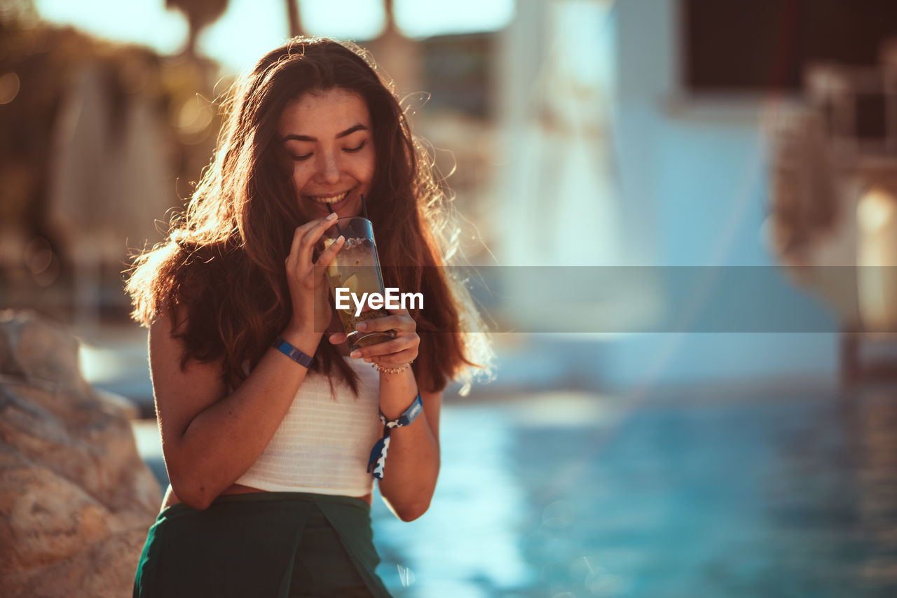 Portrait of a smiling young woman standing outdoors