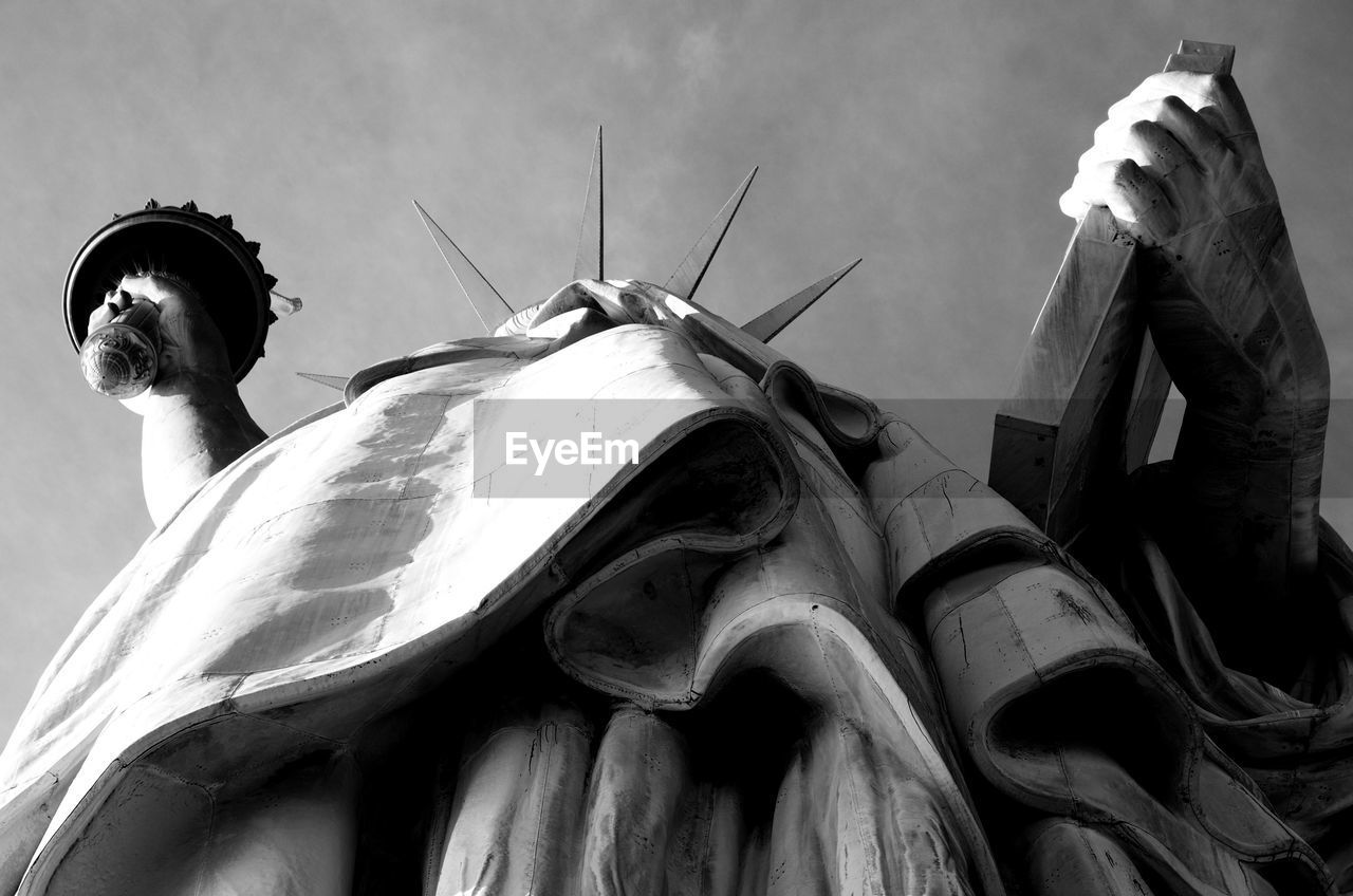 Low angle view of statue of liberty against sky