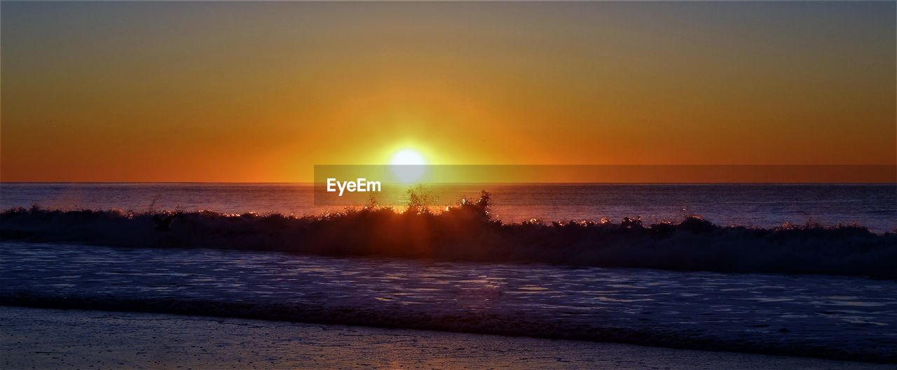 Scenic view of sea against clear sky during sunset