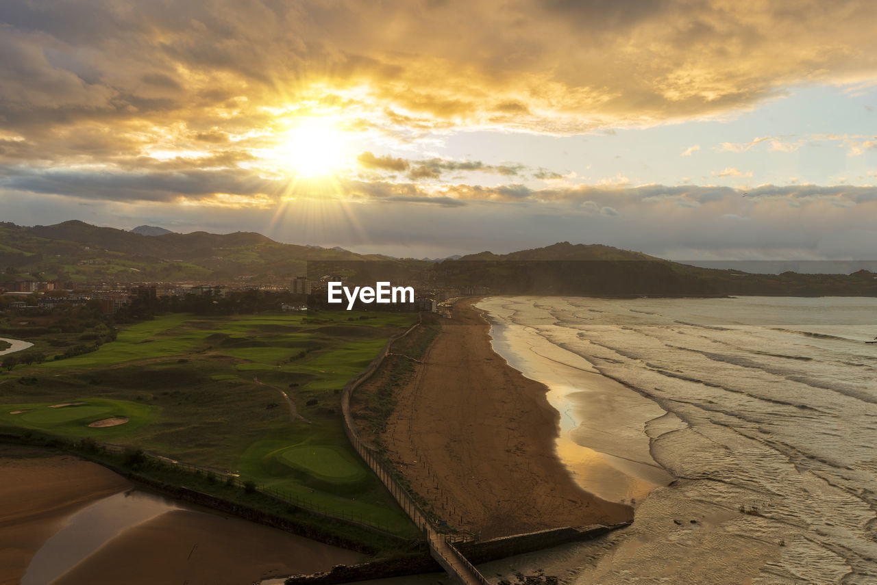 PANORAMIC SHOT OF LAND AGAINST SKY DURING SUNSET