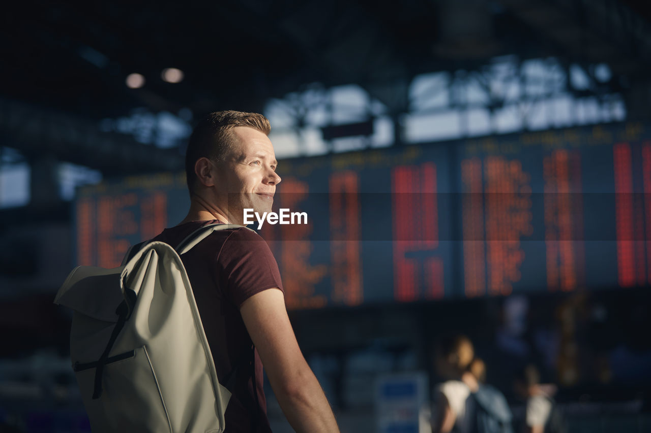 Traveling by airplane. portrait of man walking through airport terminal.