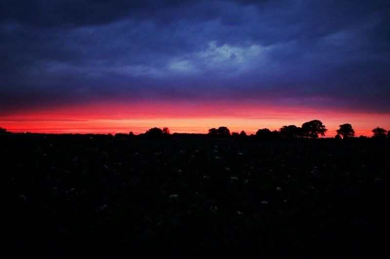 SILHOUETTE OF LANDSCAPE AGAINST DRAMATIC SKY