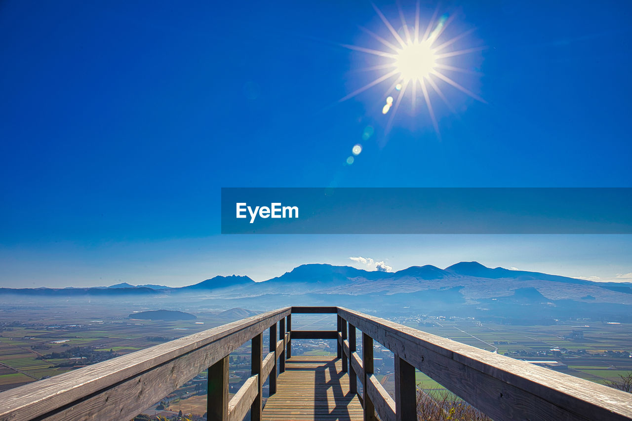 Scenic view of mountains against blue sky