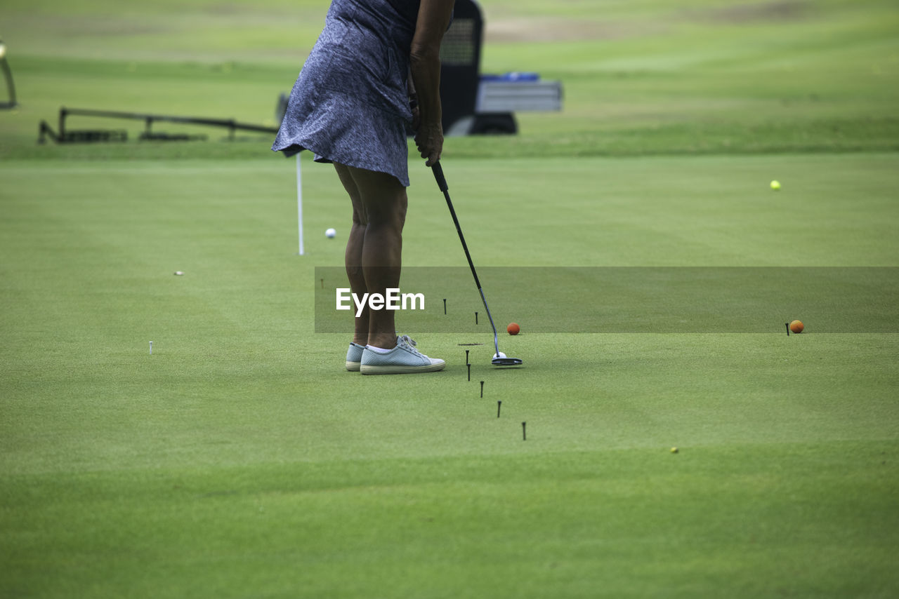 A rearview shot of an active elderly woman playing golf and enjoying outdoor recreation in mexico