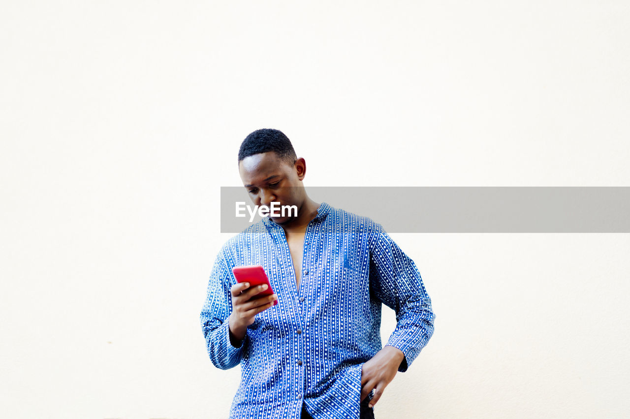 Young african man using his smartphone