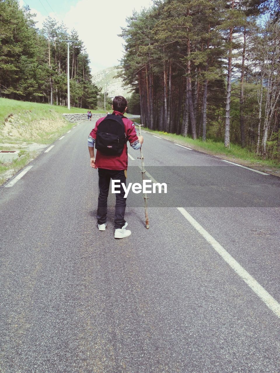 High angle view of hiker standing on road