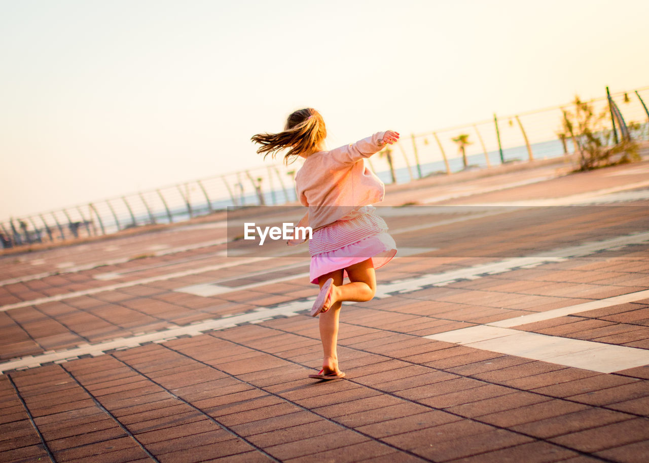 Rear view of girl running outdoors