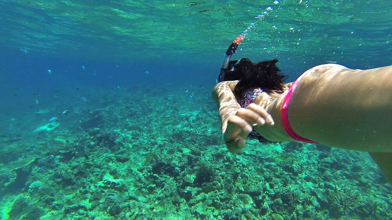 Side view of woman snorkeling in sea
