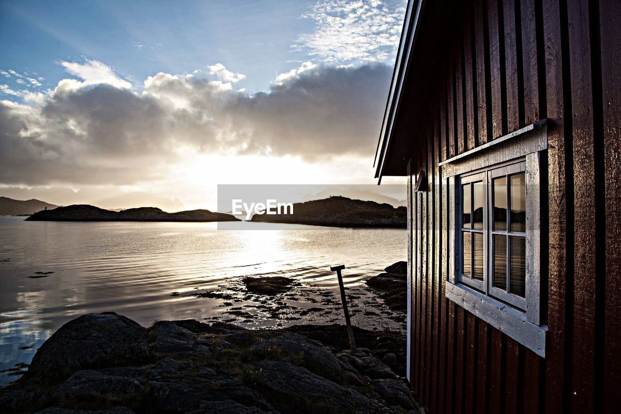 Cropped image of wooden house at lakeshore