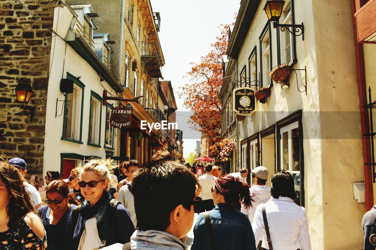 People amidst buildings in city