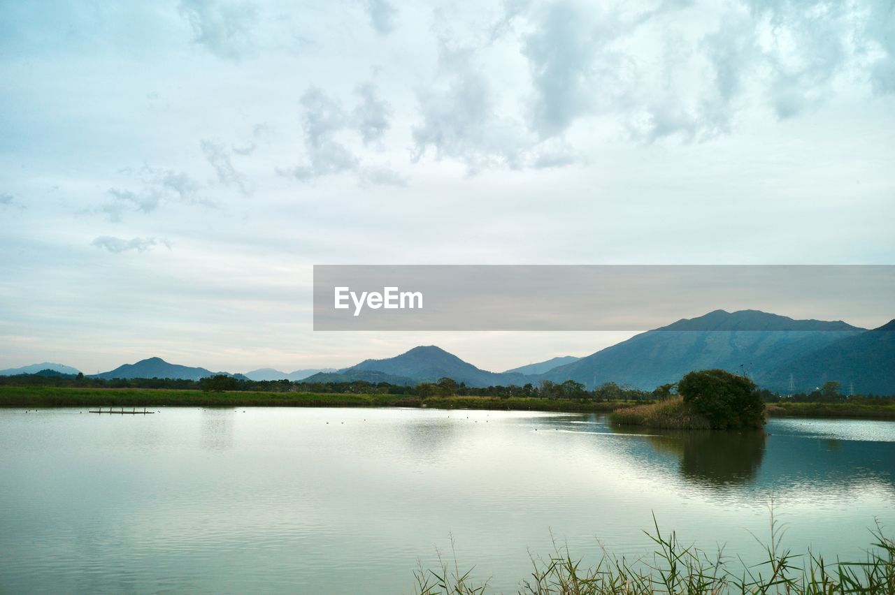 water, mountain, reflection, lake, sky, scenics - nature, nature, beauty in nature, cloud, tranquility, mountain range, tranquil scene, environment, reservoir, landscape, no people, body of water, morning, plant, non-urban scene, travel destinations, day, land, tree, idyllic, outdoors, travel, horizon, highland, remote