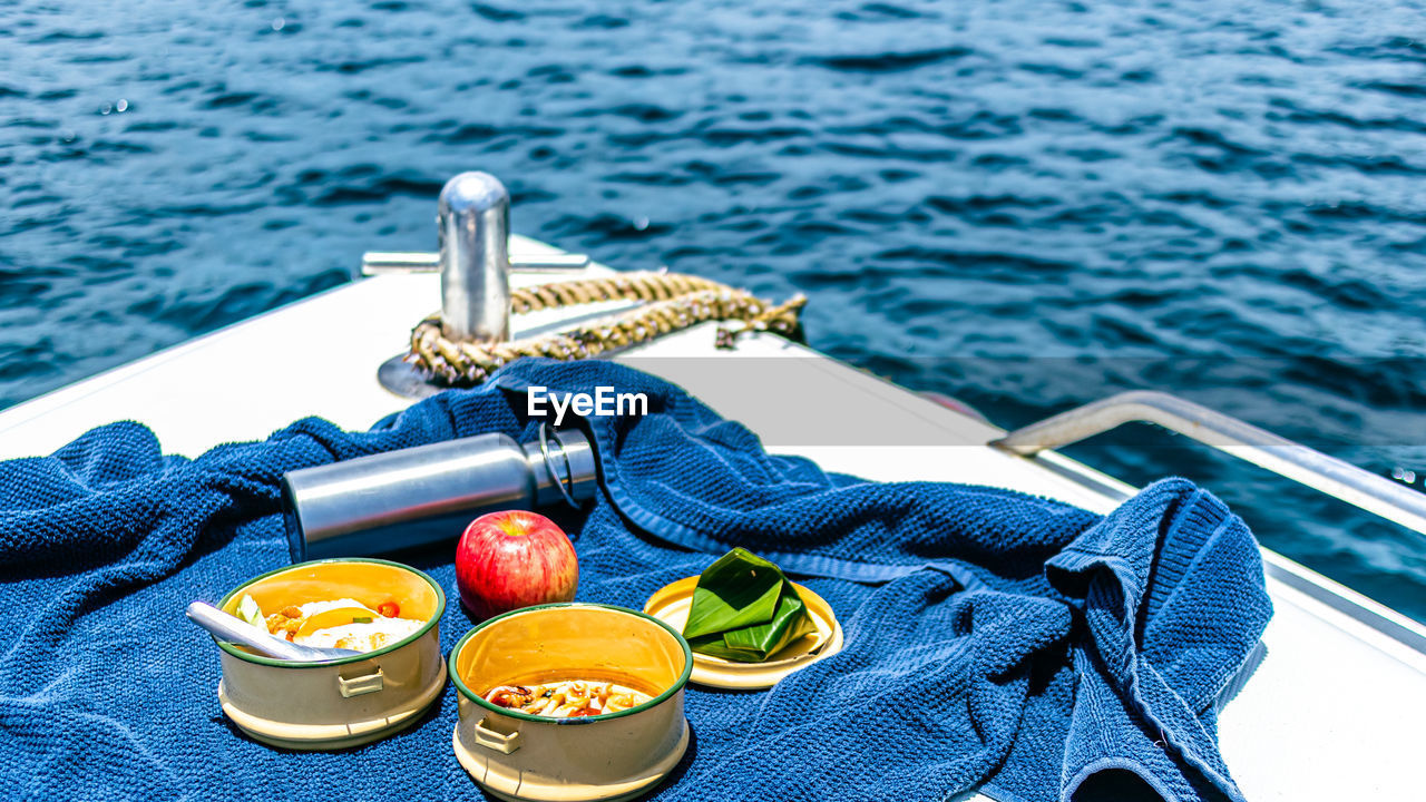 water, food and drink, food, boat, fruit, nautical vessel, sea, no people, vehicle, blue, healthy eating, day, high angle view, nature, watercraft, transportation, boating, outdoors, summer