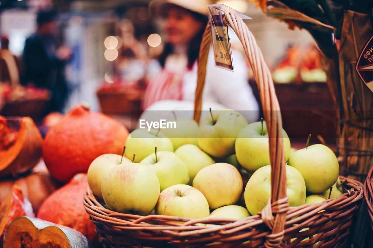 Apples in basket for sale at market stall