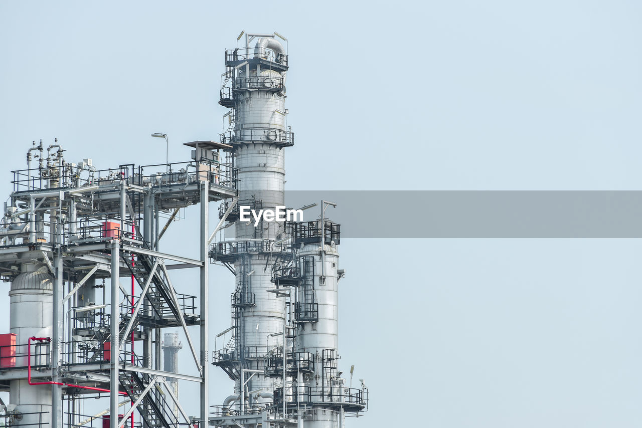LOW ANGLE VIEW OF FACTORY AGAINST CLEAR SKY