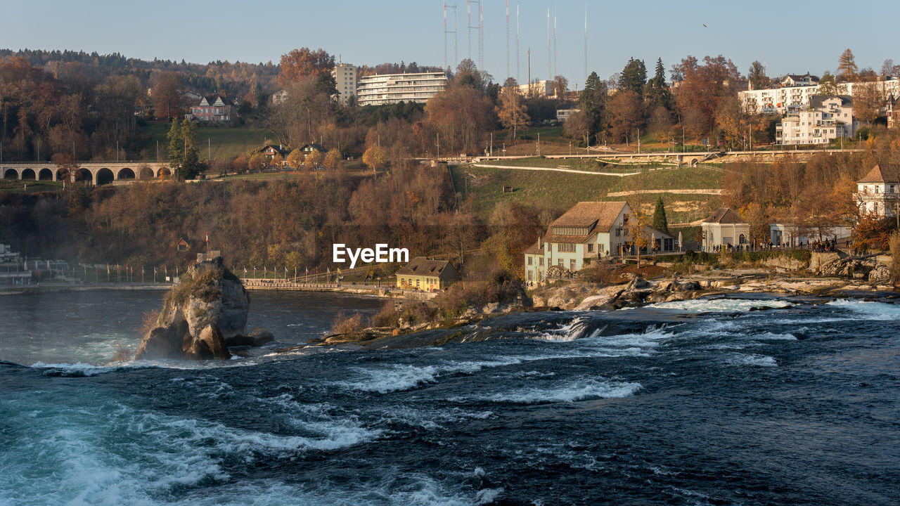 SCENIC VIEW OF RIVER BY BUILDINGS AGAINST SKY