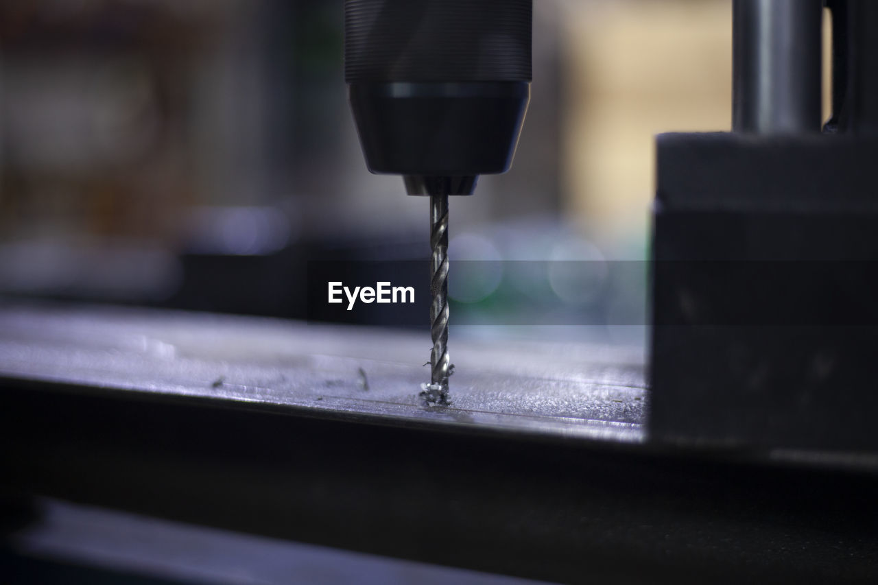 A modern drill for creating holes in metal. work as a drill in the workshop. 