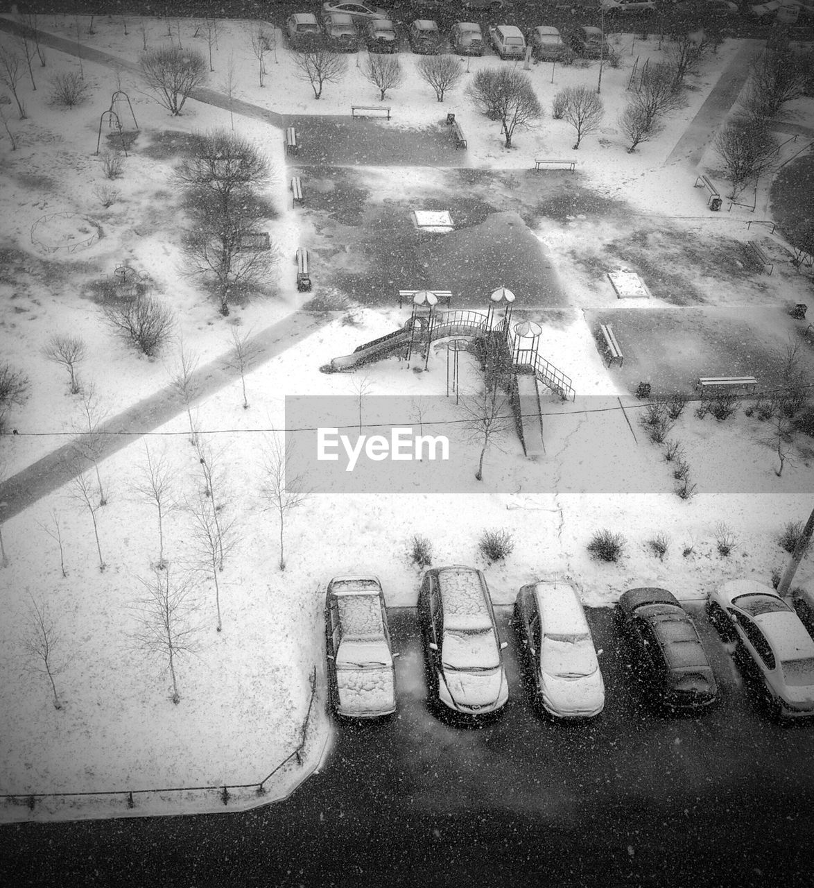 High angle view of slides and cars in snow