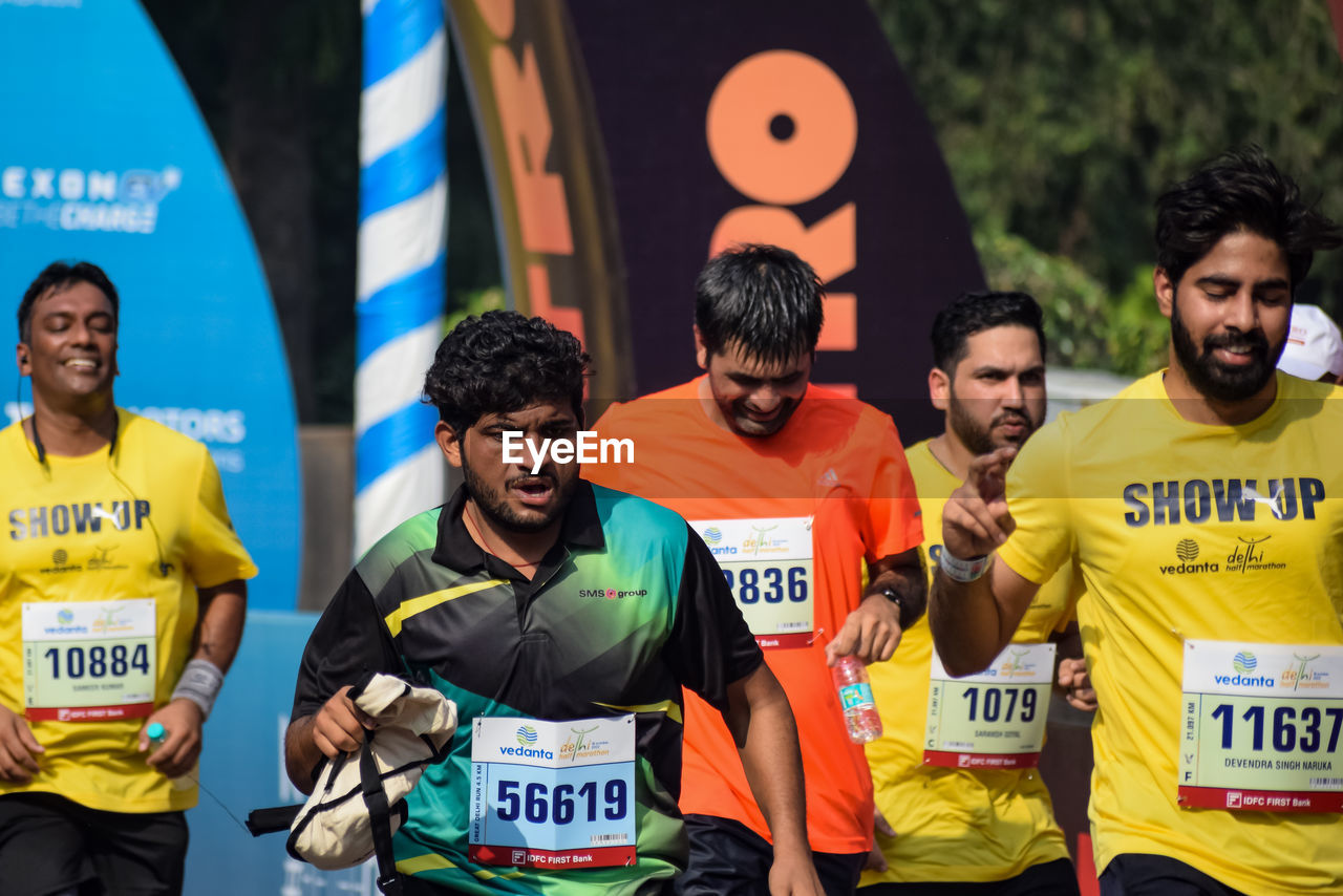 person, adult, men, long distance running, sports, group of people, track and field event, running, recreation, young adult, individual sports, smiling, happiness, lifestyles, emotion, competition, communication, event