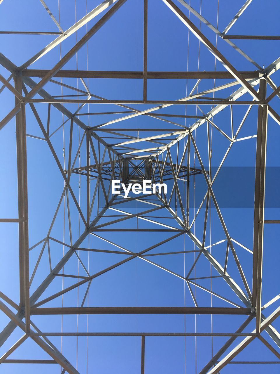 ELECTRICITY PYLON AGAINST BLUE SKY