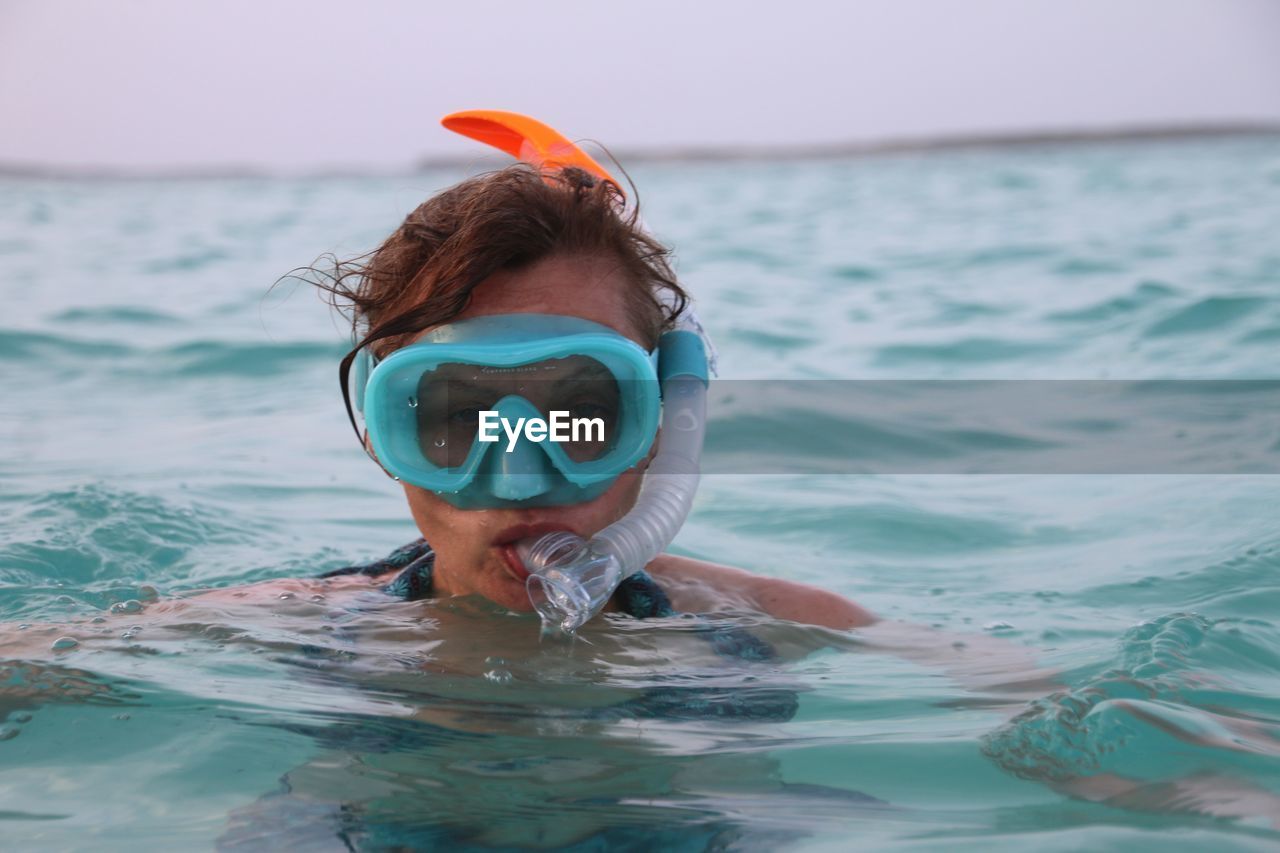 Portrait of woman swimming in sea