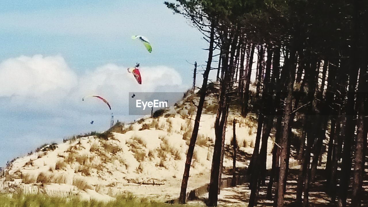 PERSON PARAGLIDING AGAINST SKY