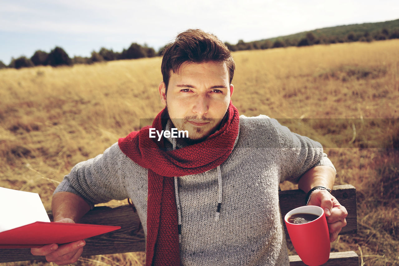 PORTRAIT OF YOUNG MAN DRINKING COFFEE CUP