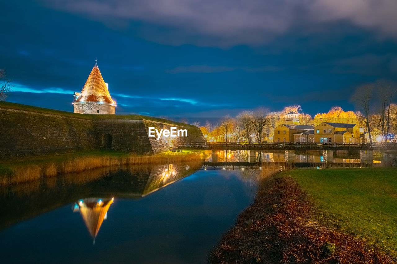 reflection of illuminated buildings in lake