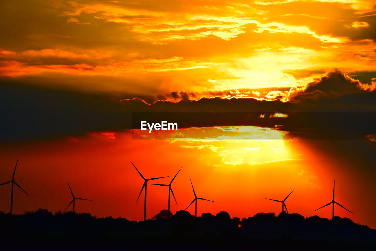 SILHOUETTE OF WIND TURBINE AGAINST SKY AT SUNSET