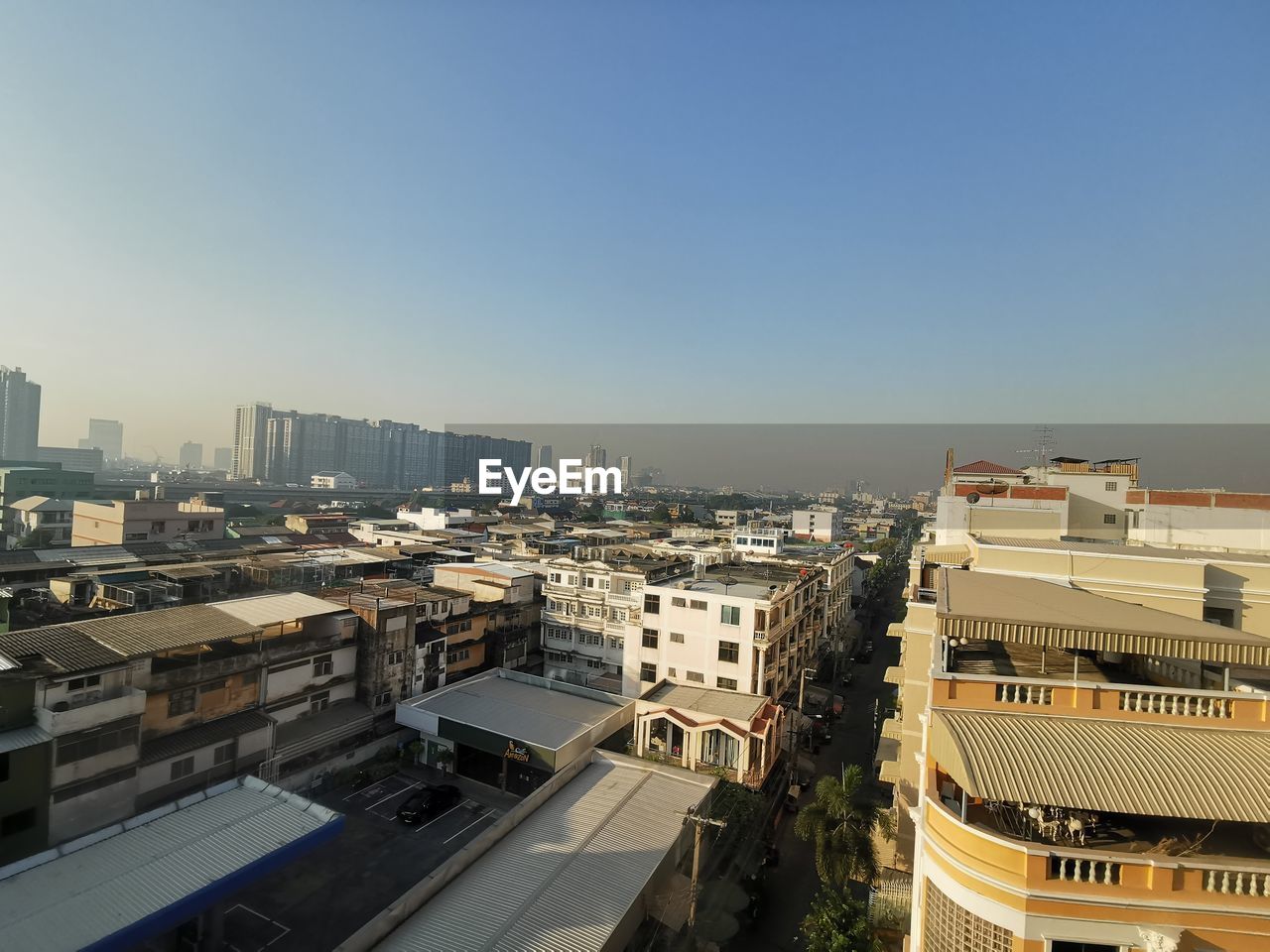 HIGH ANGLE VIEW OF STREET AMIDST BUILDINGS IN CITY