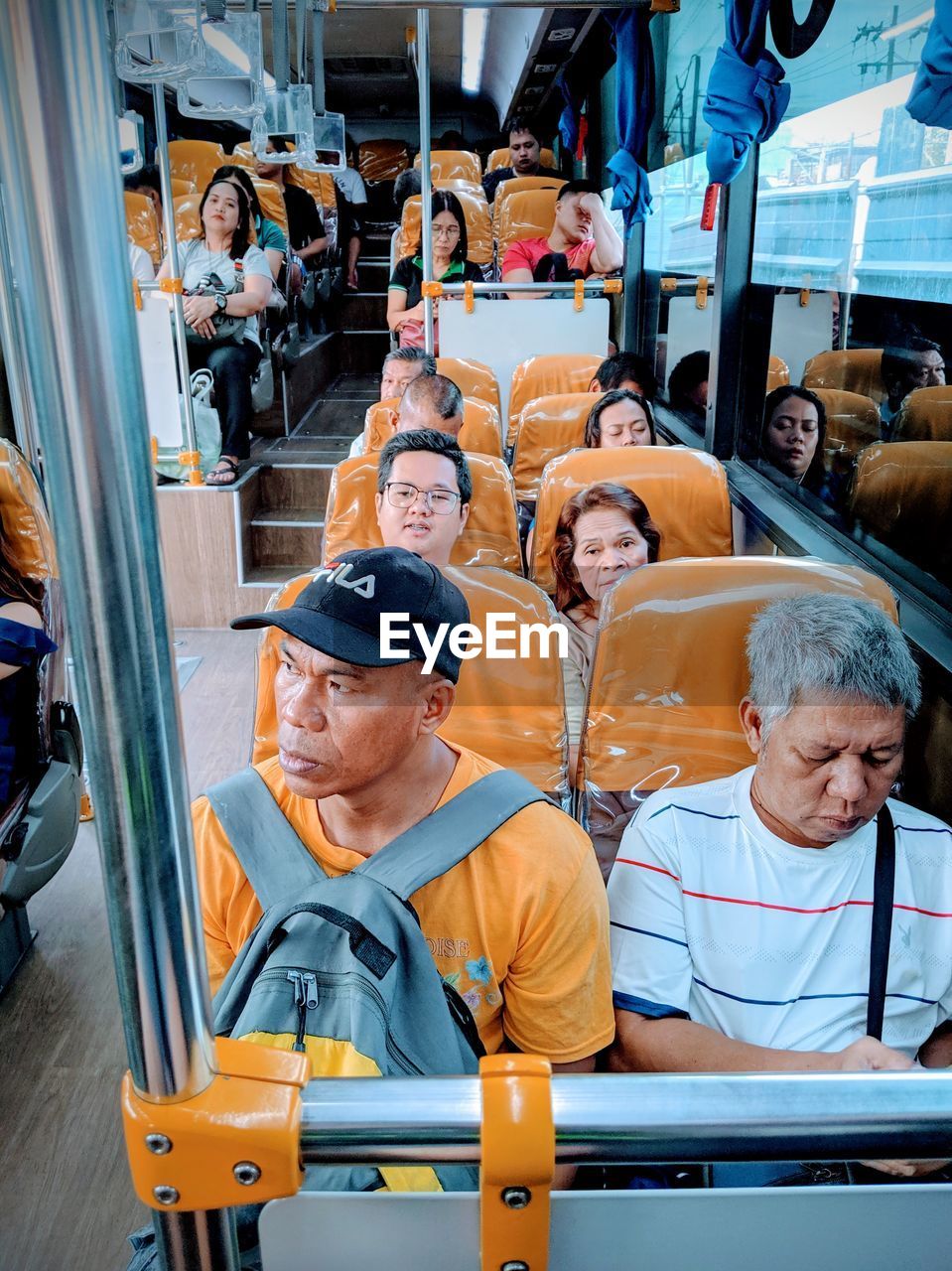 GROUP OF PEOPLE IN BUS AT STATION