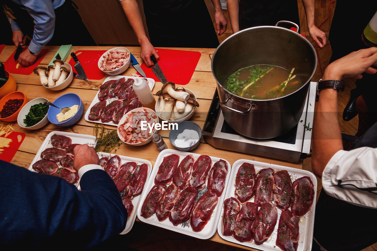 Process of cooking meat and soup at masterclass in restaurant