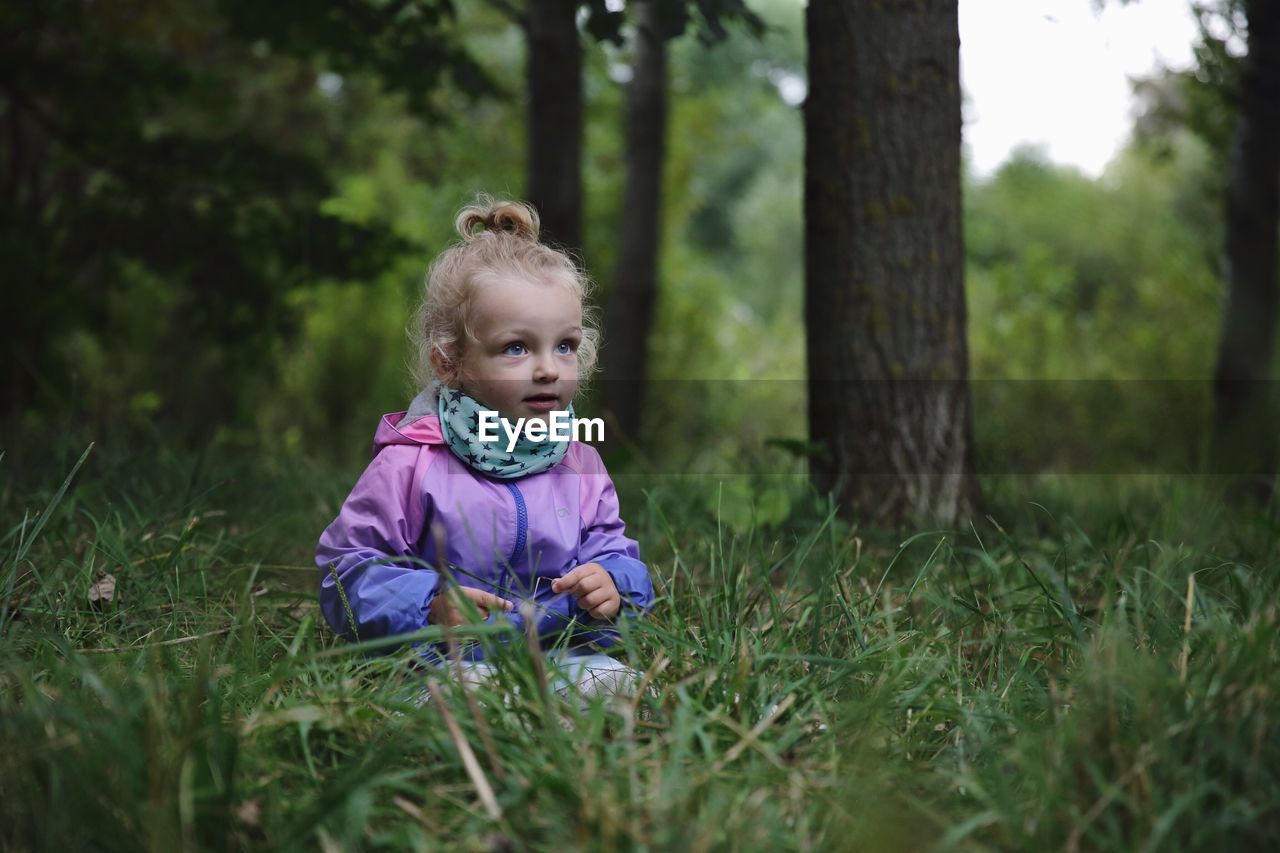 Portrait of girl sitting on field