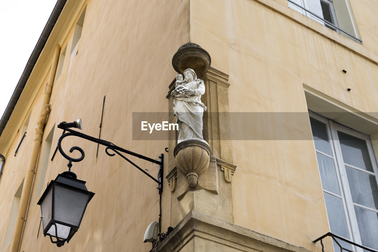 Center of aix en provence, on the corners of buildings are saints of the catholic religion.