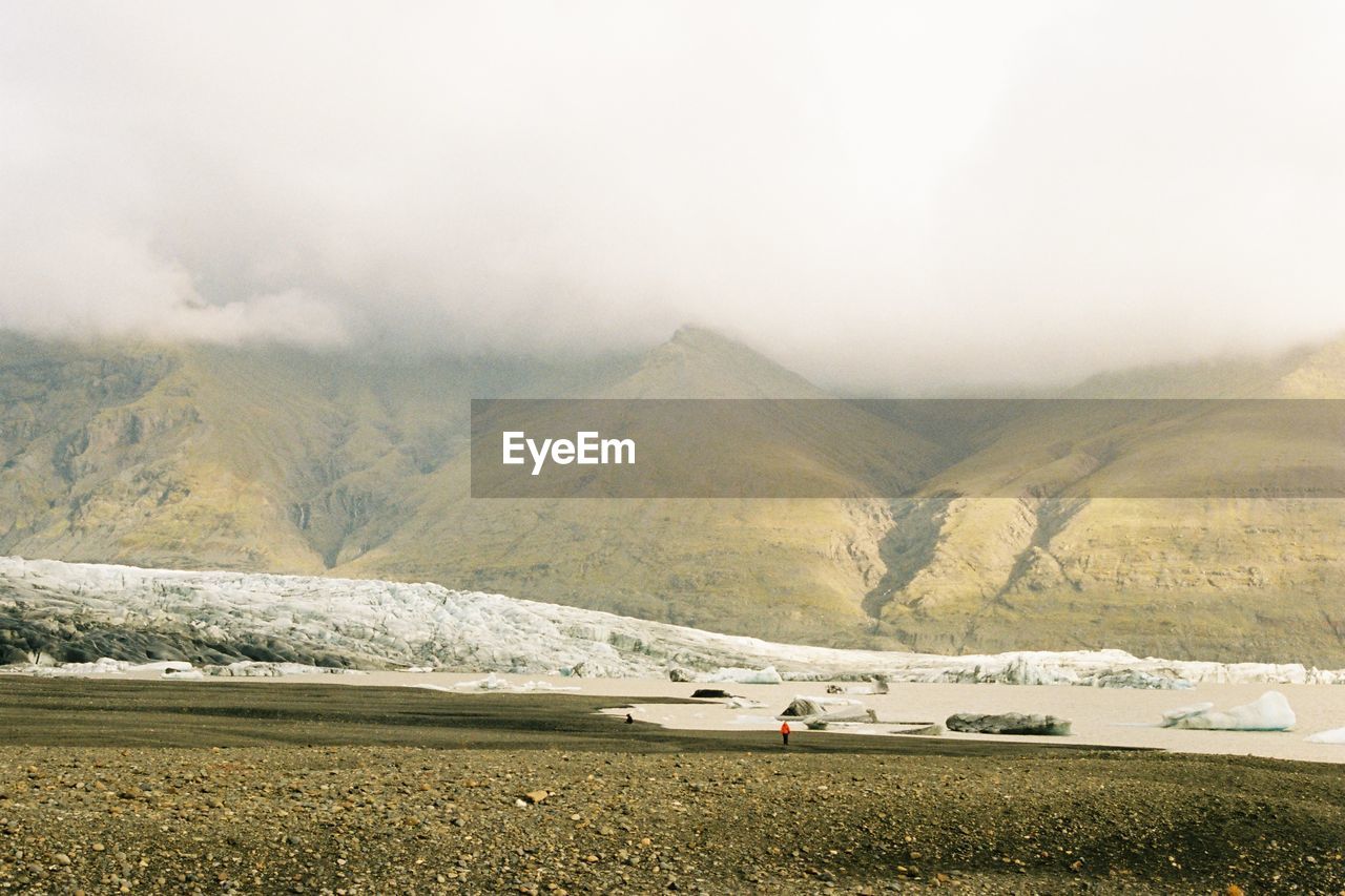 Scenic view of mountains amidst clouds