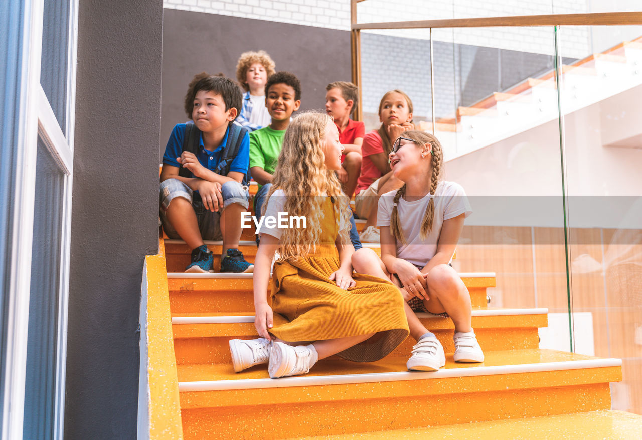 Friends sitting on staircase