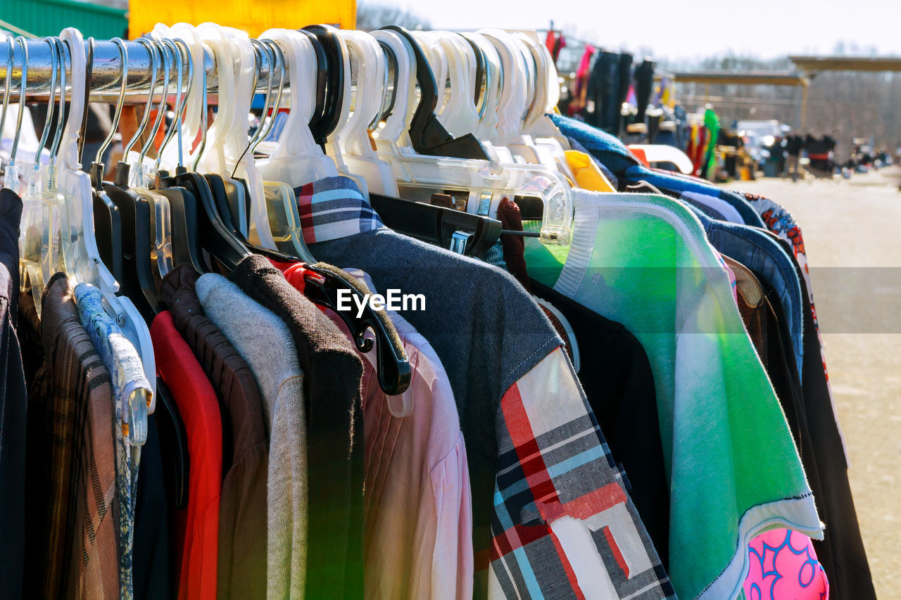 Clothes hanging on rack for sale at market