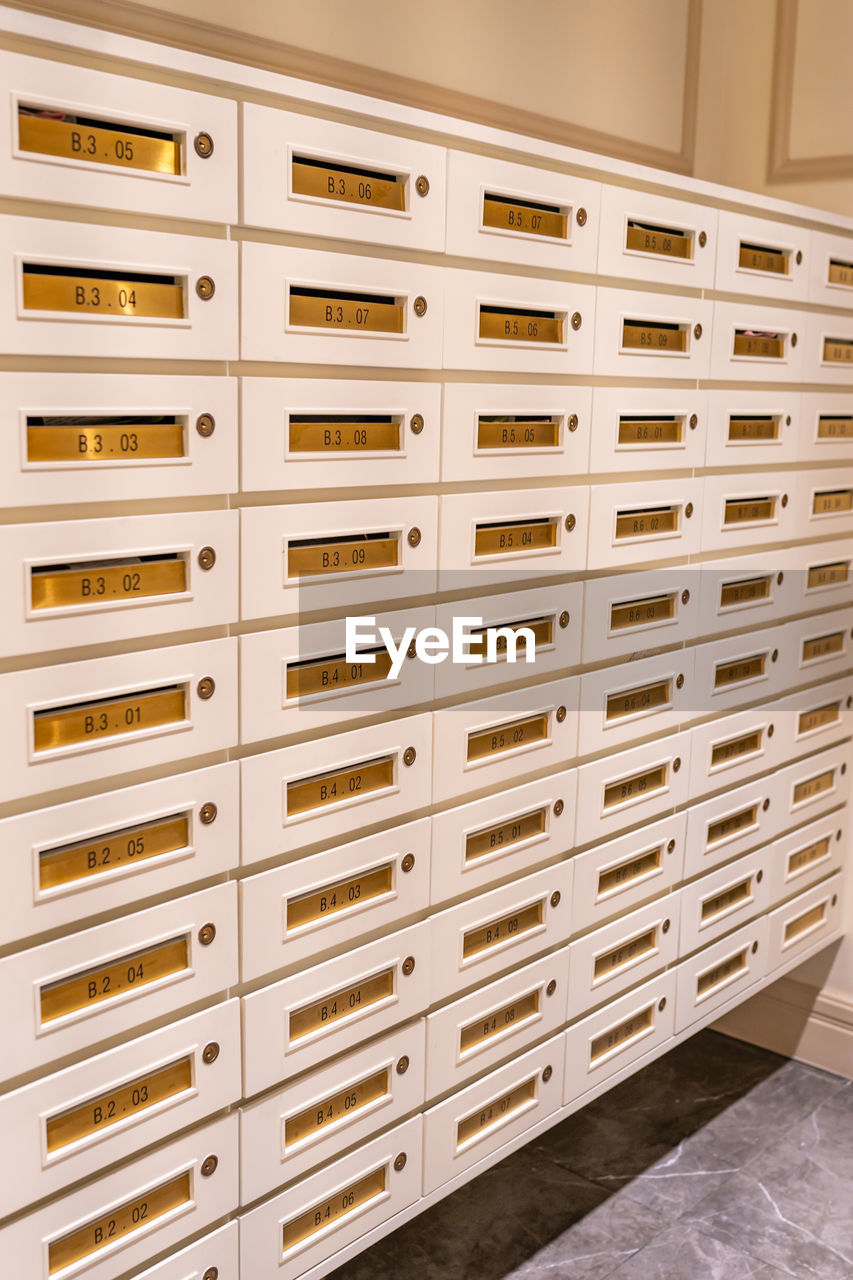 Vertical photo of letter mailboxes in postal room of condominium building