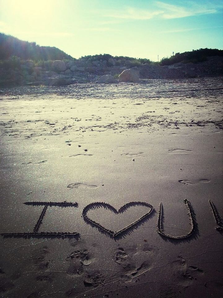 I love you text etched in beach sand
