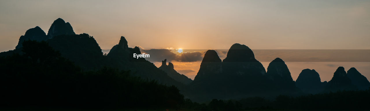 Panoramic view of silhouette mountains against sky during sunset