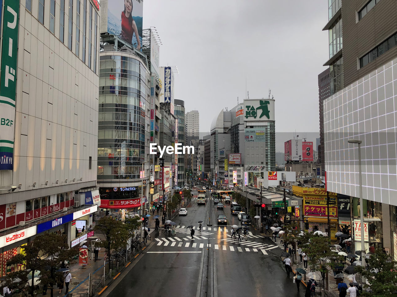 STREET AMIDST BUILDINGS IN CITY AGAINST SKY