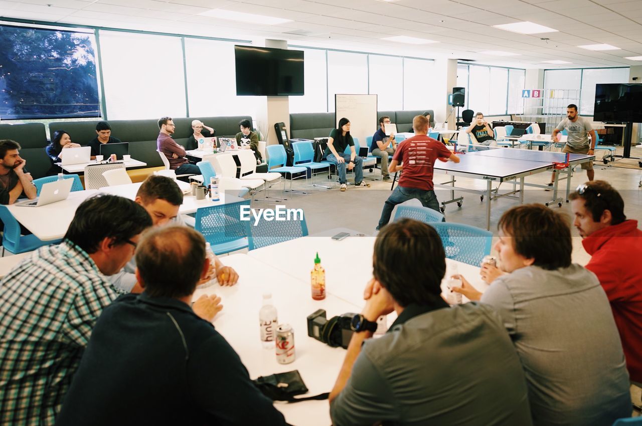 GROUP OF PEOPLE WORKING IN OFFICE BUILDING