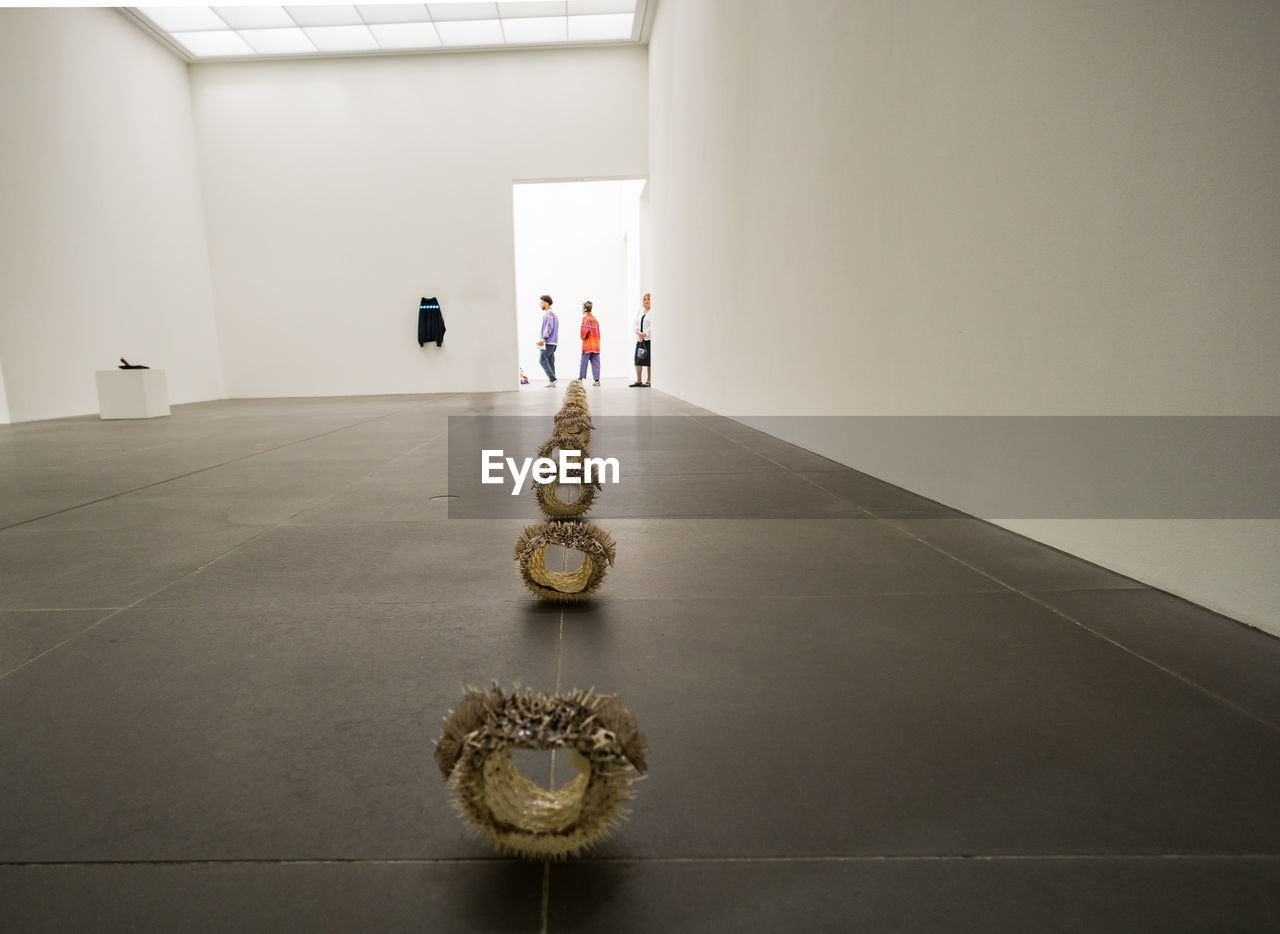 REAR VIEW OF MAN AND WOMAN WALKING IN BUILDING