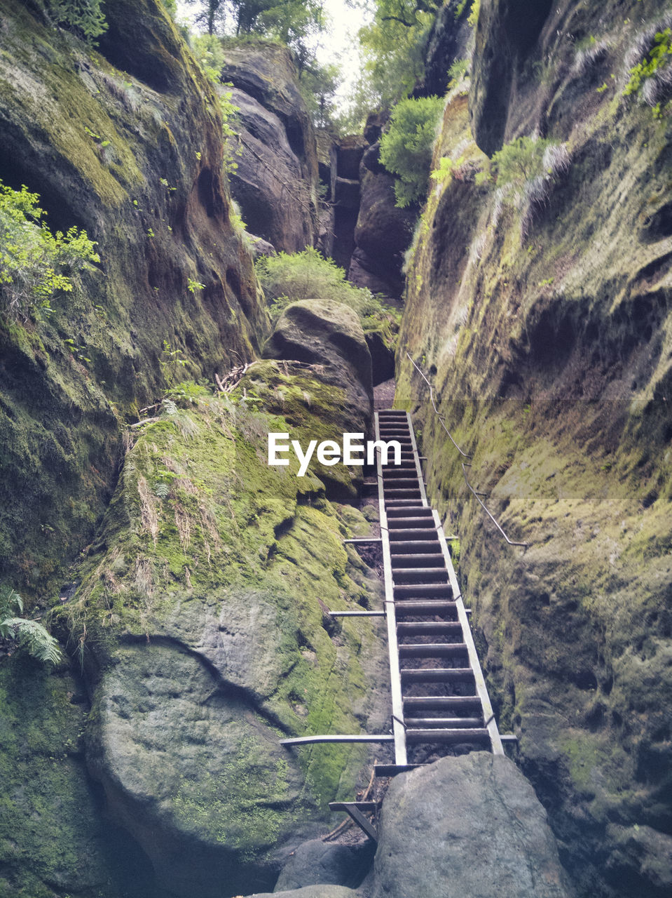 HIGH ANGLE VIEW OF ROAD AMIDST ROCKS AGAINST MOUNTAINS