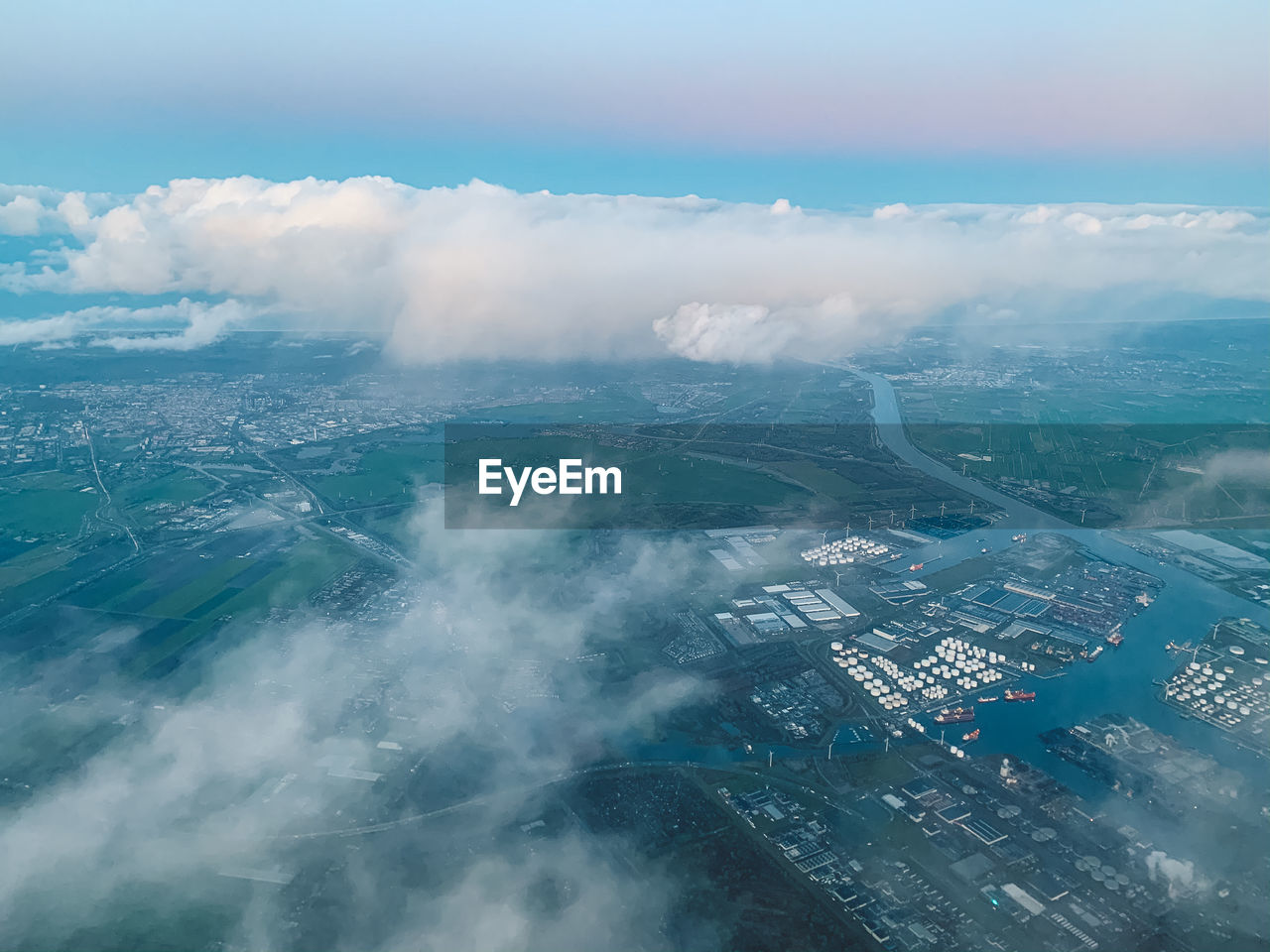 Aerial view of sea and buildings against sky