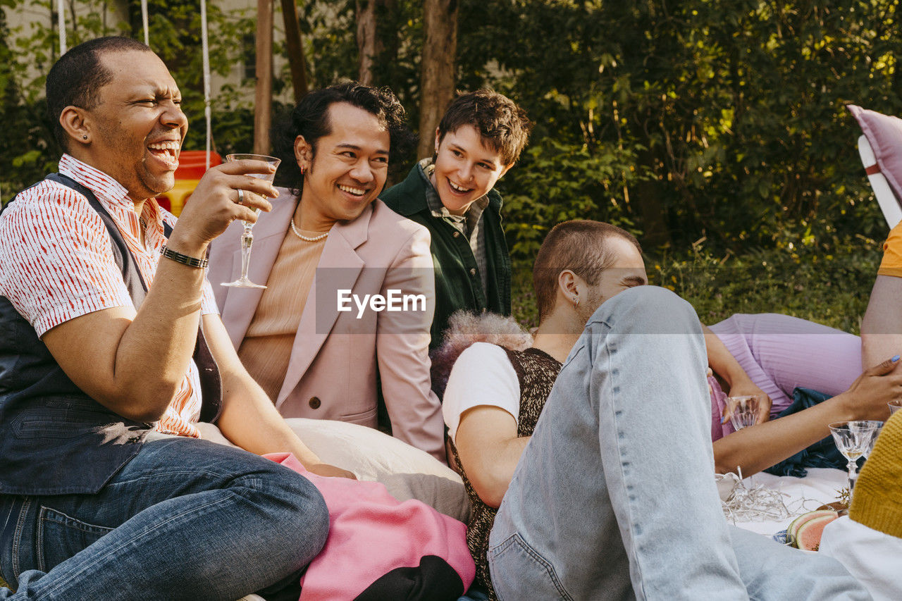 Cheerful friends from lgbtq community having fun during party in back yard